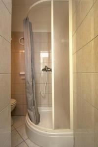 a shower with a shower curtain in a bathroom at Apartment Zecevo Rtic 8366d in Rogoznica