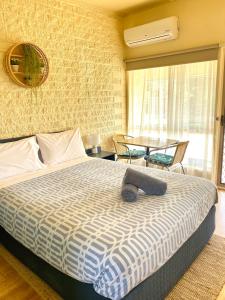 a bedroom with a large bed and a large window at Rye Beach Motel Australia in Rye