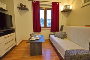 a living room with a couch and a table at Apartments with parking space Jelsa, Hvar - 8713 in Jelsa