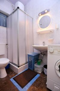 ein Badezimmer mit einem Waschbecken, einem WC und einem Spiegel in der Unterkunft Apartments by the sea Zecevo Rtic, Rogoznica - 10334 in Rogoznica