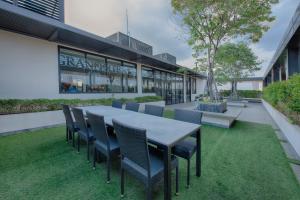 a table and chairs on a lawn in front of a building at GRANFERTE Phnom Penh Hotel in Phnom Penh