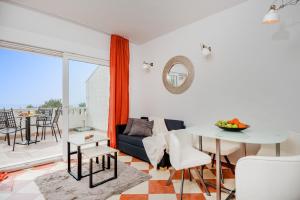 a living room with a table and a couch at Apartments and rooms with parking space Rogoznica - 10339 in Rogoznica
