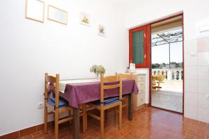 a kitchen and dining room with a table and chairs at Apartments by the sea Drvenik Veliki, Drvenik - 10346 in Veliki Drvenik +13 photos