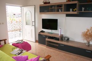 a living room with a flat screen tv on a wall at Holiday house with a swimming pool Bol, Brac - 11016 in Bol