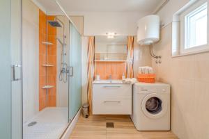 a bathroom with a washing machine and a shower at Apartments by the sea Slatine, Ciovo - 11047 in Slatine