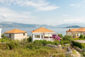 a house with a view of the water at Apartments by the sea Slatine, Ciovo - 11047 in Slatine