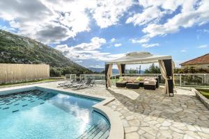 a swimming pool with a gazebo next to a house at Luxury villa with a swimming pool Dubravka, Dubrovnik - 11073 in Gruda