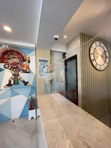 a room with a clock on the wall and a hallway at Hotel Simone Kalibo in Kalibo