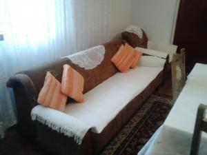 a couch with pillows on it in a living room at Apartments with parking space Maslenica, Novigrad - 11089 in Maslenica