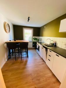 a kitchen with a table and chairs and a sink at Mainberger in Schonungen