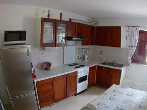a kitchen with a refrigerator and a stove top oven at Apartments with a parking space Biograd na Moru, Biograd - 11150 in Biograd na Moru
