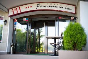 a hotel entrance with a sign on top of it at Hotel Panoramic in Râmnicu Vâlcea