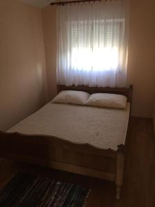 een kleine slaapkamer met een bed en een raam bij Apartments by the sea Slatine, Ciovo - 11126 in Slatine