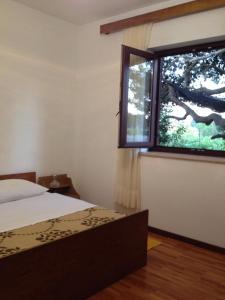 a bedroom with a bed and a large window at Holiday house with a parking space Valbandon, Fazana - 11172 in Marana