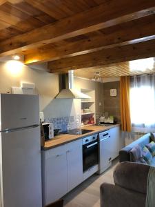 a kitchen with a refrigerator and a stove at Casa rural los 7 pinos de Gredos in Navarredonda de Gredos