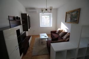 a living room with a couch and a table at Apartments by the sea Krk - 11205 in Krk