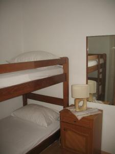 a bedroom with two bunk beds and a lamp on a night stand at Apartments by the sea Lumbarda, Korcula - 11275 in Lumbarda