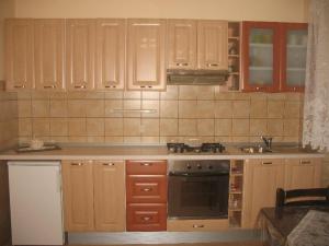 a kitchen with wooden cabinets and a stove top oven at Apartments by the sea Lumbarda, Korcula - 11275 in Lumbarda +15 photos