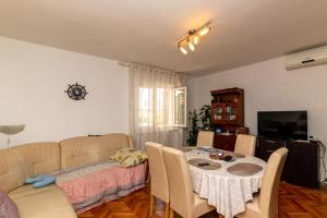 a living room with a couch and a table at Apartment Supetar 11278a in Supetar