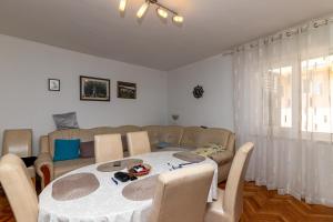 a living room with a table and a couch at Apartment Supetar 11278a in Supetar