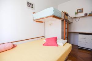 a bedroom with a bed with a bunk bed at Apartments by the sea Splitska, Brac - 11300 in Splitska