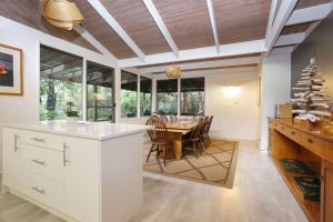 a kitchen and dining room with a table and chairs at Sandy Shores in Hawks Nest