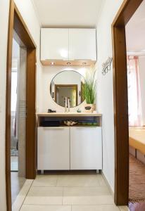 a bathroom with a sink and a mirror at Apartments by the sea Splitska, Brac - 11300 in Splitska