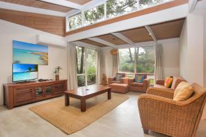 a living room with a flat screen tv and furniture at Sandy Shores in Hawks Nest