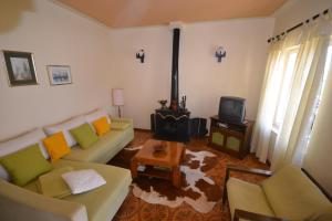 a living room with a couch and a stove at Apartments by the sea Splitska, Brac - 11339 in Splitska