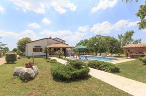 a villa with a swimming pool and a house at Holiday house with a swimming pool Orihi, Central Istria - Sredisnja Istra - 11295 in Barban