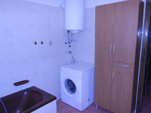 a laundry room with a washing machine and a sink at Holiday house with a swimming pool Orihi, Central Istria - Sredisnja Istra - 11295 in Barban