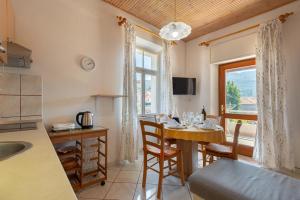 a kitchen and dining room with a table and a window at Apartment Jelsa 11319a in Jelsa