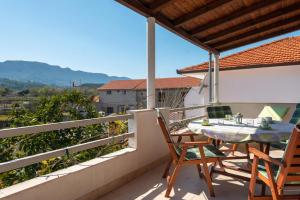 a patio with a table and chairs on a balcony at Apartment Jelsa 11319a in Jelsa