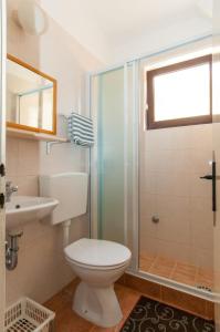 a bathroom with a toilet and a shower and a sink at Apartments with a parking space Mali Losinj (Losinj) - 11344 in Mali Lošinj