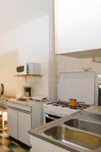 a kitchen with a sink and a stove at Apartments with a parking space Mali Losinj (Losinj) - 11344 in Mali Lošinj
