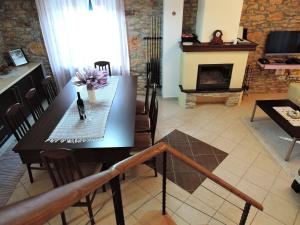 a living room with a table and a fireplace at Family friendly house with a swimming pool Gluici, Krka - 11337 in Validžići