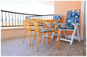 two chairs and a table and chairs on a balcony at Apartments by the sea Razanj, Rogoznica - 11347 in Rogoznica