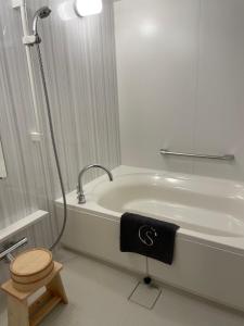 a bathroom with a toilet and a bath tub at Sakura Cross Hotel Kyoto Kiyomizu in Kyoto