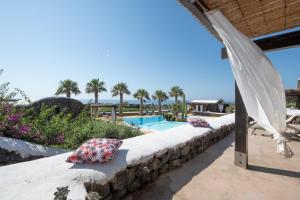 a resort with a swimming pool and palm trees at Residenza delle Palme in Pantelleria