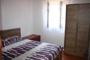 a bedroom with a bed and a dresser and a window at Secluded fisherman's cottage Cove Nevidjansko Polje, Pasman - 11392 in Neviđane