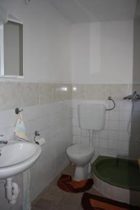 a bathroom with a toilet and a sink at Secluded fisherman's cottage Cove Nevidjansko Polje, Pasman - 11392 in Neviđane