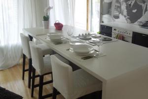 a kitchen with a table with plates and wine glasses at Apartments with a swimming pool Zagreb - 11408 in Zagreb