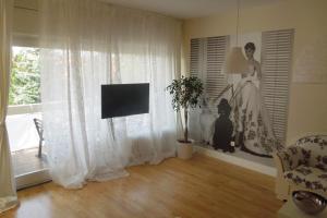 a living room with a woman in a dress on a window at Apartments with a swimming pool Zagreb - 11408 in Zagreb