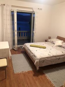a bedroom with a bed and a sliding glass door at Apartments with WiFi Pucisca, Brac - 11416 in Pučišća