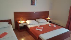 a bedroom with two beds and two lamps on tables at Apartments with a parking space Gradac, Makarska - 11332 in Gradac