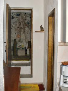 un espejo en una pared al lado de una puerta en Apartments by the sea Pisak, Omis - 10410, en Mimice