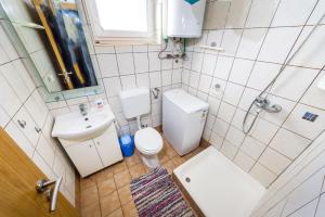 a small bathroom with a toilet and a sink at Apartments with a parking space Nin, Zadar - 10414 in Nin