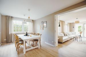 a dining room and living room with a table and chairs at Stadthytte Ferienhaus in Rostock