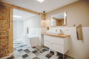 a bathroom with a sink and a mirror at Stadthytte Ferienhaus in Rostock