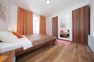 a bedroom with a bed and a large mirror at Apartments by the sea Tkon, Pasman - 8414 in Tkon